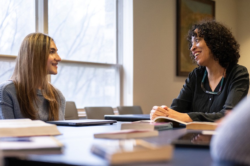 Adrienne Perry, an English professor, talks one-on-one with a student.