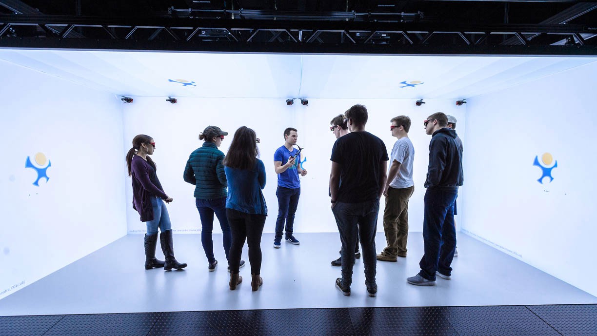 Department of Computing Sciences Students stand inside the virtual reality CAVE.