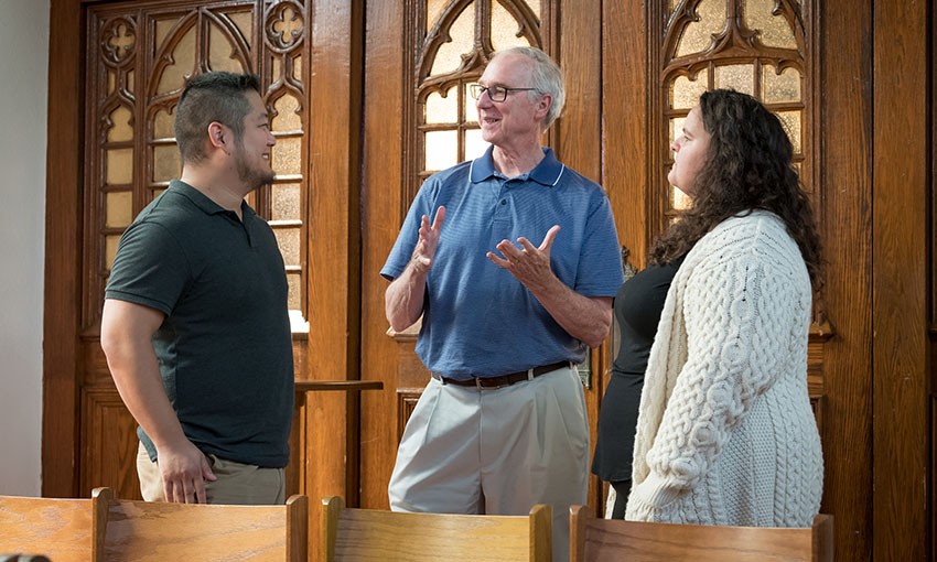 Graduate students and faculty in discussion