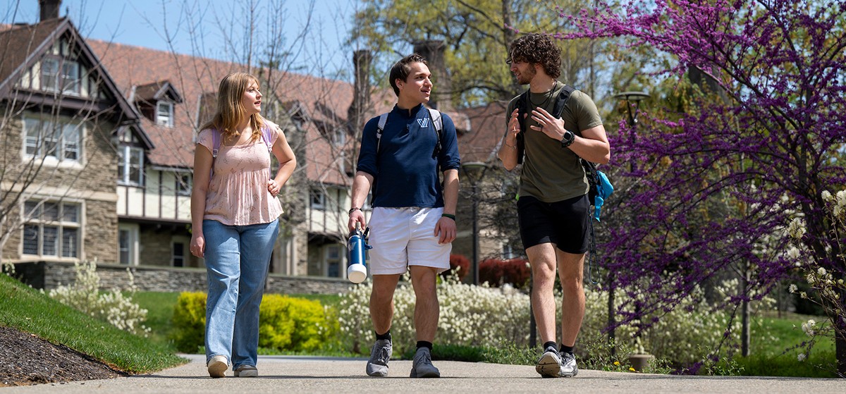 students walking on a Cabrini campus path