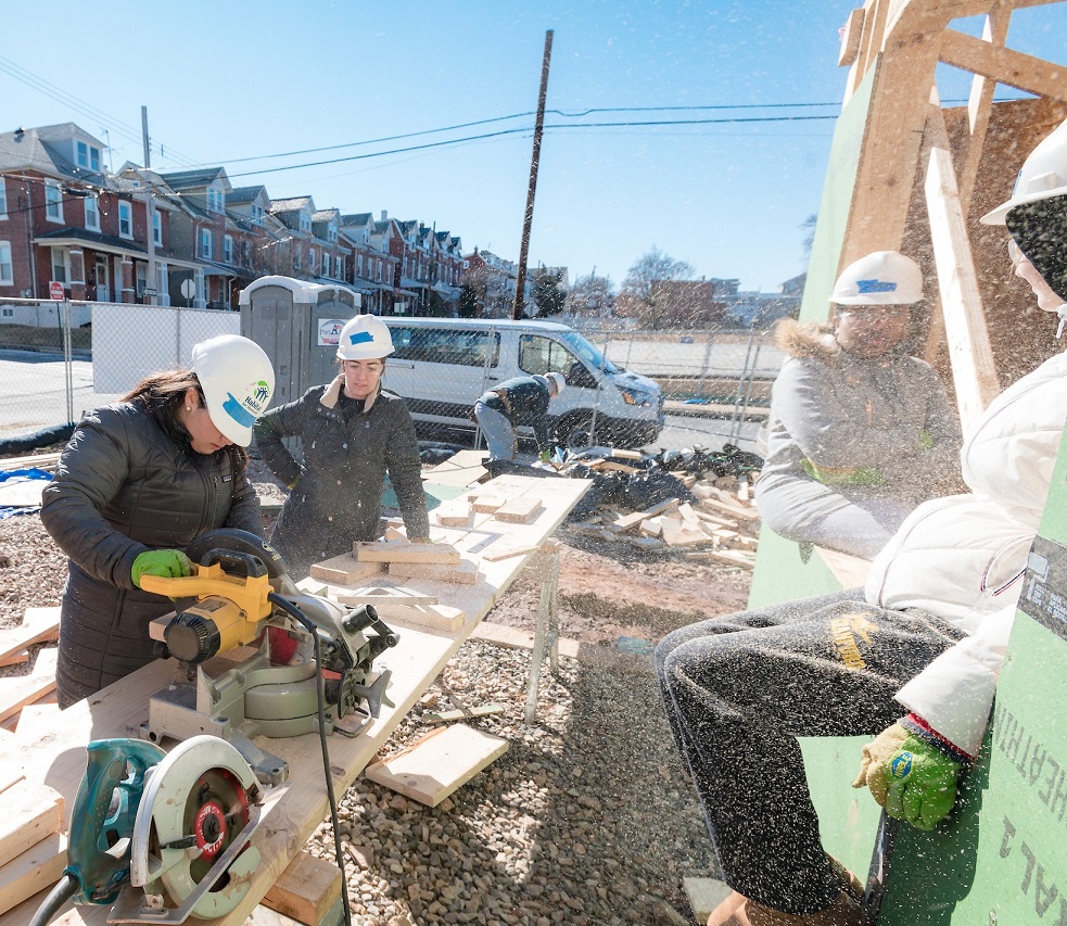Volunteers work with Habitat for Humanity building homes
