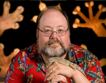 Dr. Aaron Bauer takes a headshot with a lizard.