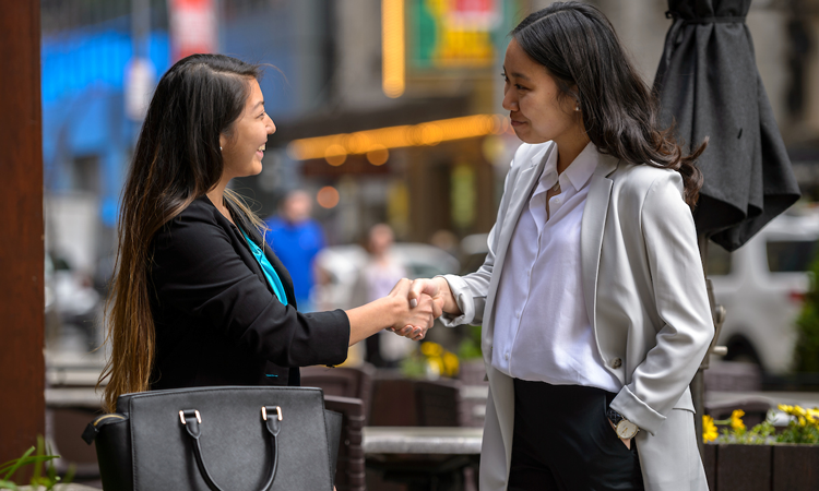 Two women shaking hands