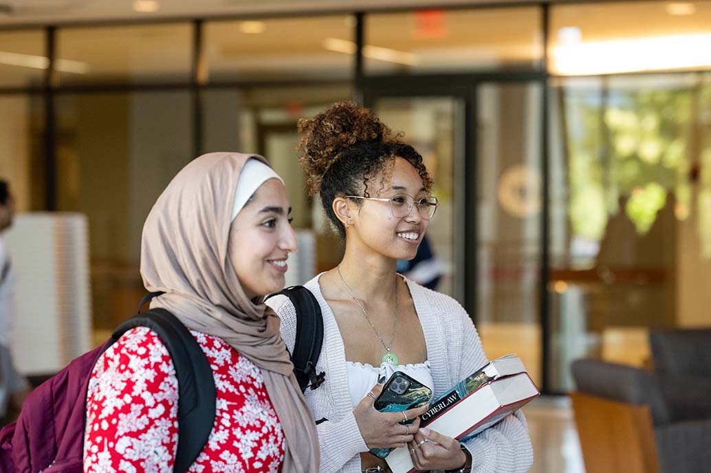 Two female law students talking outside of class.