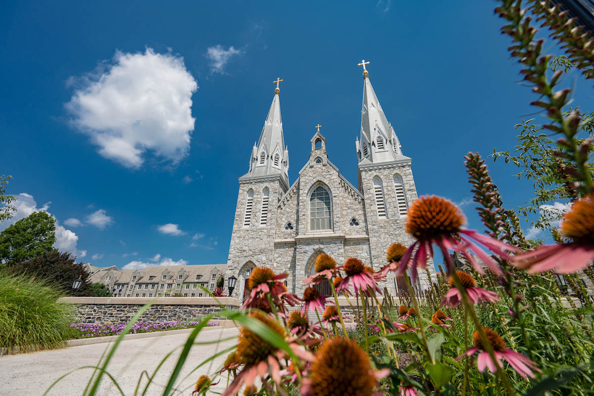 Image of St Thomas of Villanova Church with flowers in front