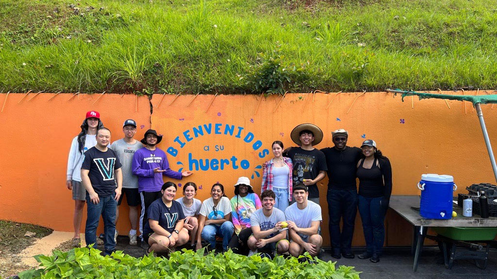 Villanova students posing for a picture next to a wall