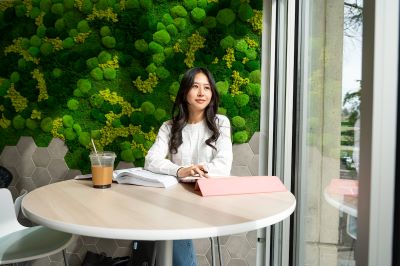 woman working on a tablet in a coffee shop