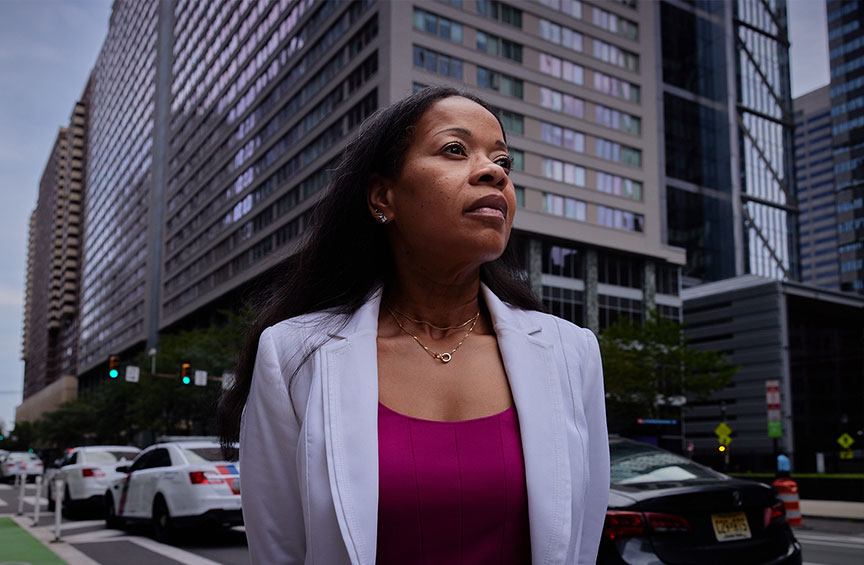 Erica Howard dressed in business attire standing near busy Philadelphia street