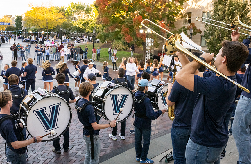 The Villanova Marching Band perform outside on campus. 
