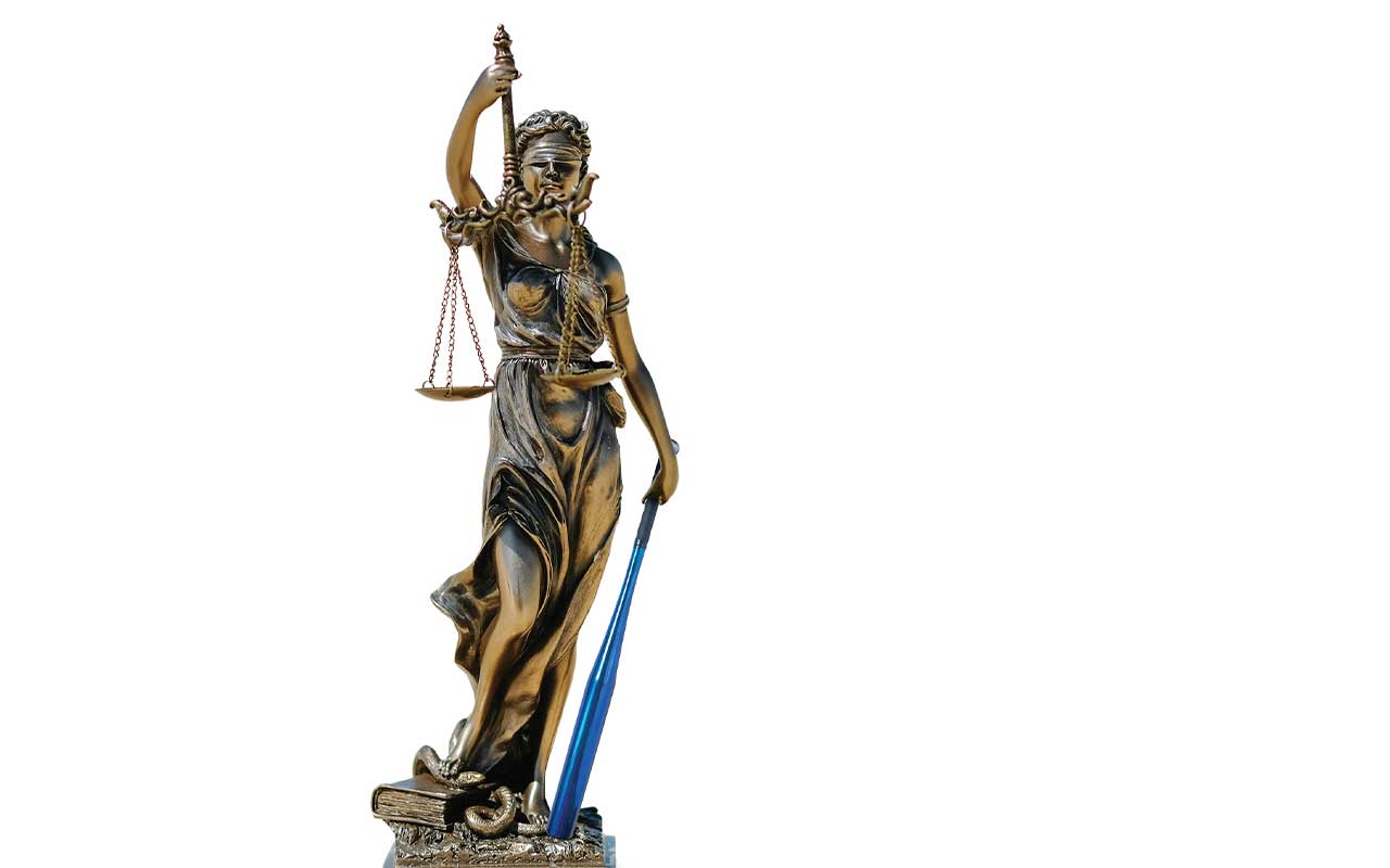 A statue of Lady Justice holding a blue Villanova baseball bat.